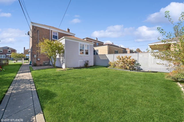 rear view of property featuring a yard