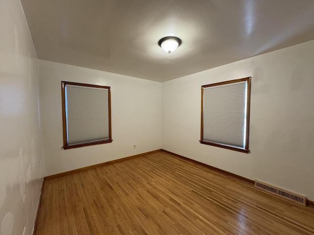 spare room featuring hardwood / wood-style floors