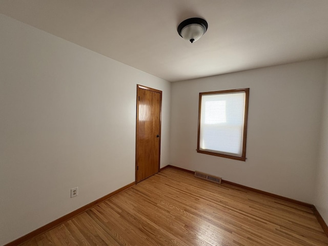 spare room featuring light hardwood / wood-style flooring