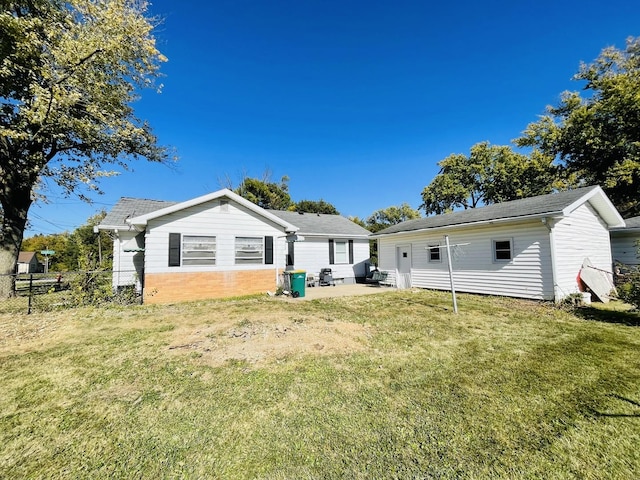 rear view of house featuring a yard and a patio area