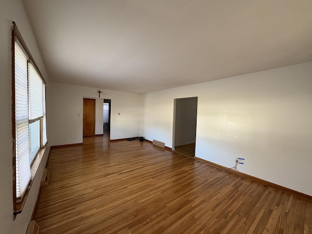 empty room with dark hardwood / wood-style floors