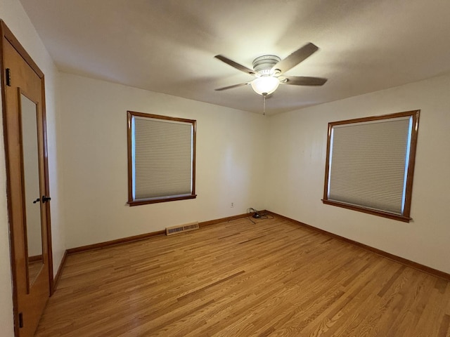 empty room with light hardwood / wood-style flooring and ceiling fan