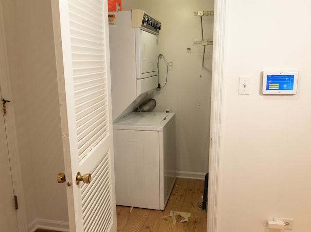 washroom featuring light wood-type flooring and stacked washing maching and dryer