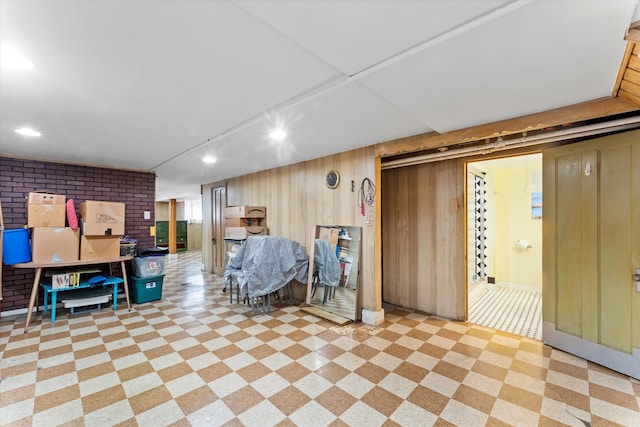 basement featuring wooden walls