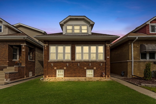 back house at dusk with a yard