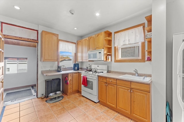 kitchen featuring sink, radiator heating unit, white appliances, and light tile patterned floors