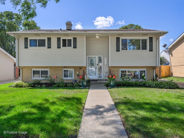 raised ranch featuring a front lawn