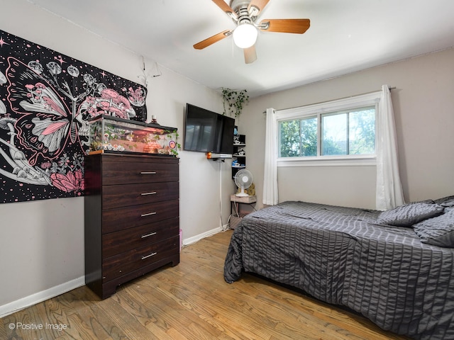 bedroom with light wood-type flooring and ceiling fan