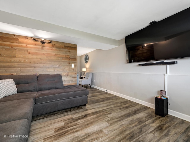 unfurnished living room with hardwood / wood-style floors and wooden walls