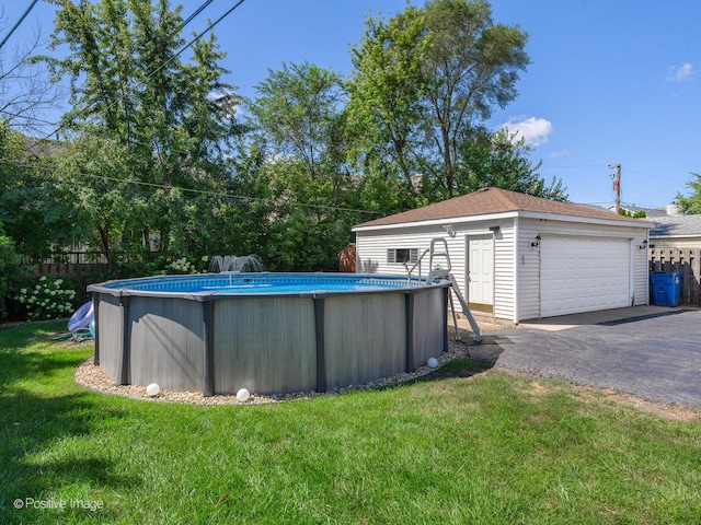 view of pool featuring a lawn and an outbuilding