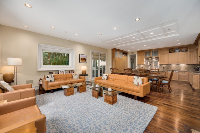 living room with dark hardwood / wood-style flooring and plenty of natural light