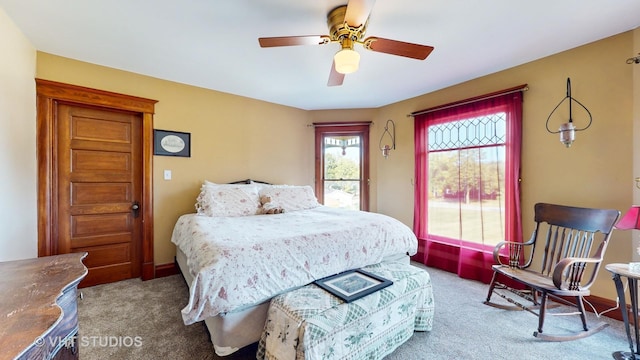 carpeted bedroom with a ceiling fan and baseboards