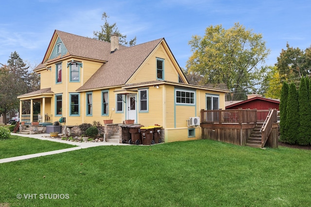 back of property with a wooden deck and a lawn