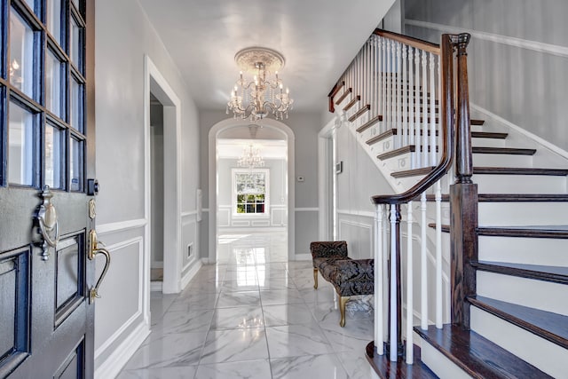 foyer entrance with a chandelier