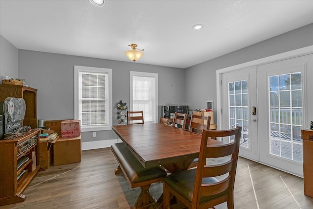 dining area with french doors, hardwood / wood-style flooring, and plenty of natural light