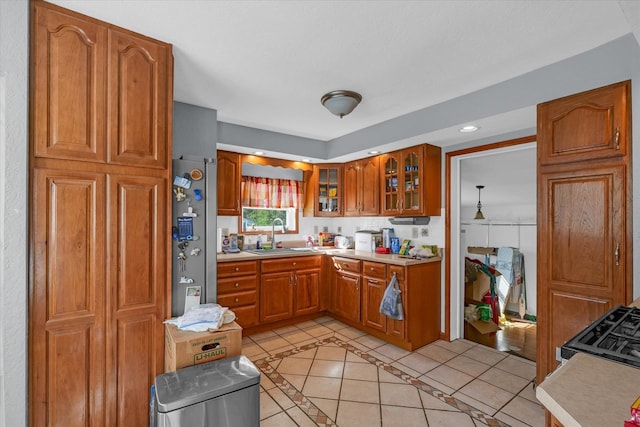 kitchen featuring light tile patterned floors, sink, and stainless steel fridge