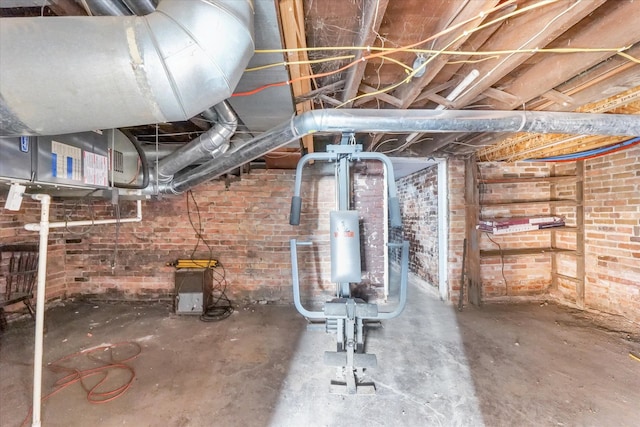 basement featuring brick wall