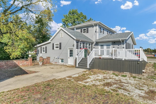 rear view of property featuring a patio and a wooden deck