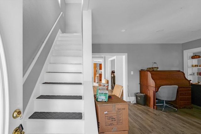 staircase with hardwood / wood-style flooring