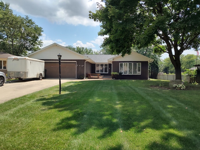 ranch-style house featuring a front yard and a garage