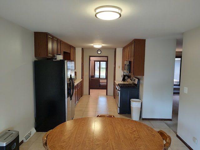 kitchen with appliances with stainless steel finishes and light tile patterned flooring