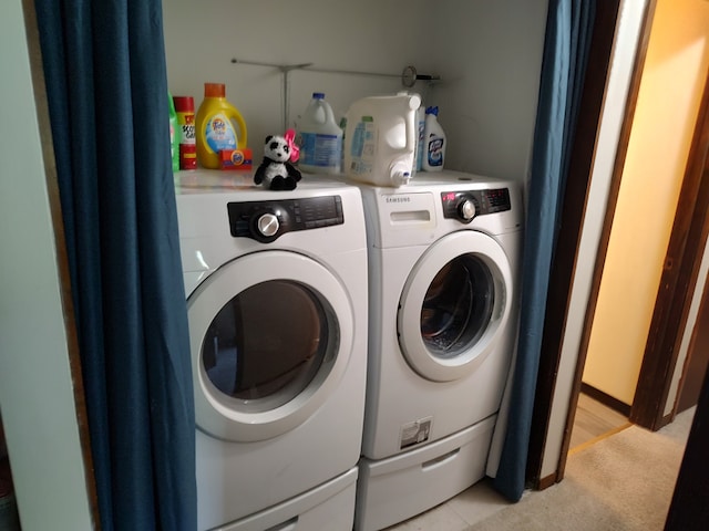 washroom with washer and dryer