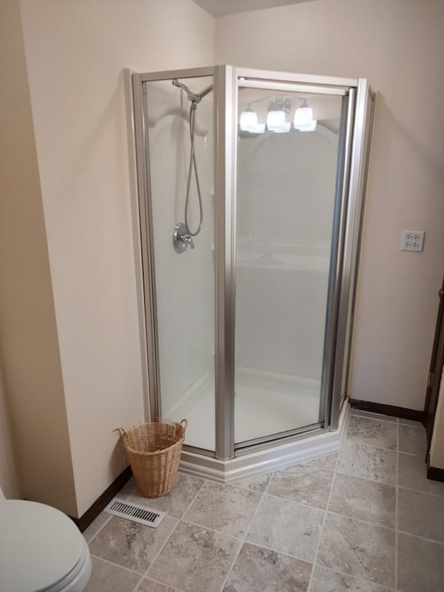 bathroom featuring toilet and walk in shower