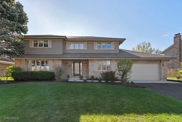 view of front facade with a garage and a front lawn