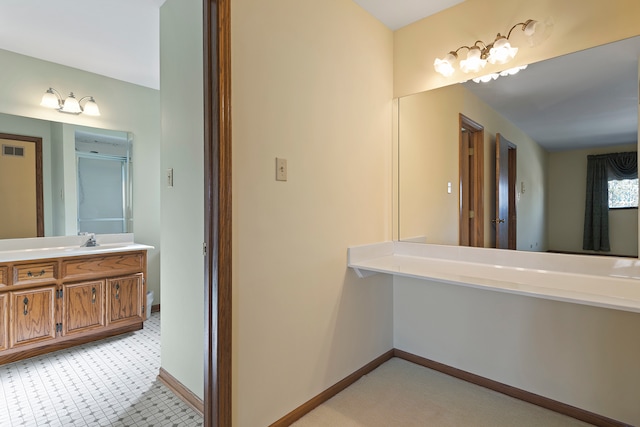 bathroom featuring a shower with door, vanity, and tile patterned floors