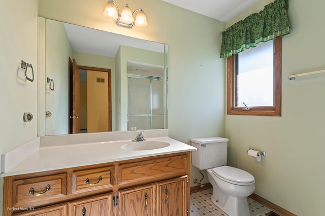 bathroom featuring toilet, walk in shower, vanity, and tile patterned floors