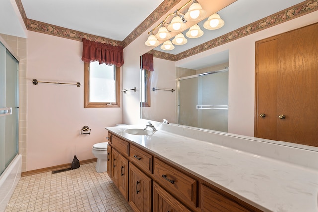 full bathroom with vanity, bath / shower combo with glass door, toilet, and tile patterned flooring