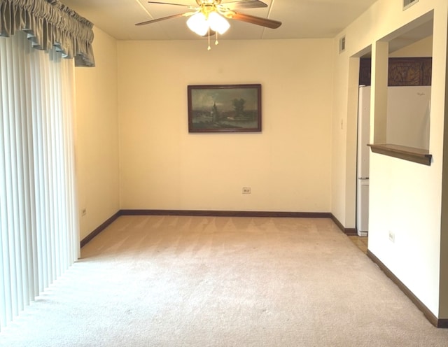 unfurnished room with ceiling fan and light colored carpet