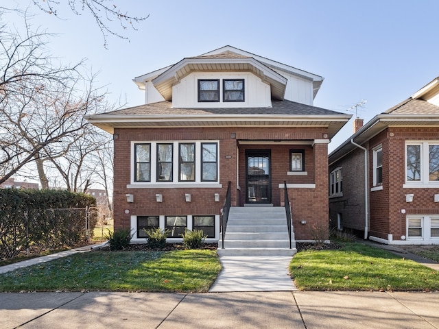 bungalow-style home with a front lawn