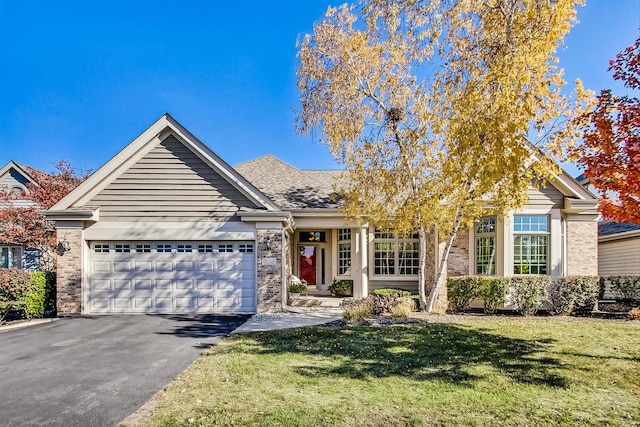 view of front of home featuring a front lawn and a garage