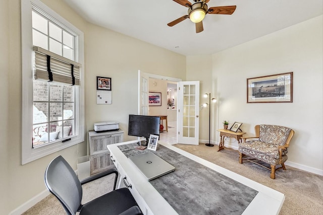 carpeted home office with french doors and ceiling fan