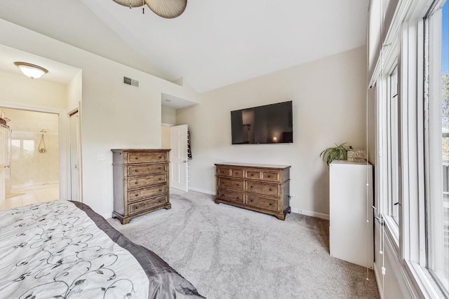 carpeted bedroom featuring ensuite bathroom, lofted ceiling, and ceiling fan