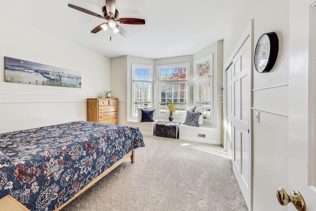 bedroom with a closet, carpet, and ceiling fan