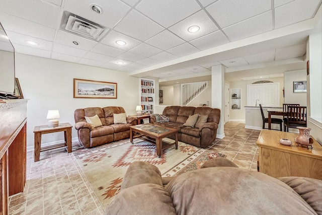 living room featuring a paneled ceiling