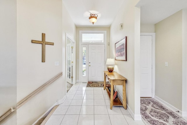 foyer with a healthy amount of sunlight and light tile patterned flooring