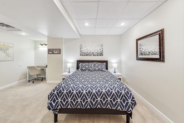 carpeted bedroom with a paneled ceiling