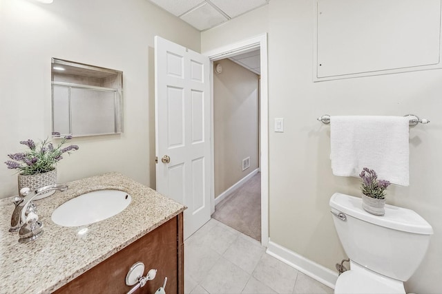 bathroom with vanity, toilet, and tile patterned flooring