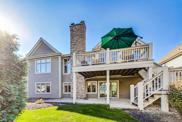 back of property with a patio area and a deck