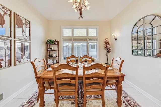 tiled dining room featuring a chandelier