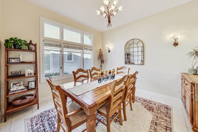 dining area featuring a notable chandelier and light tile patterned floors