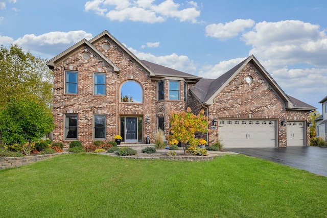 view of front of house featuring a front lawn and a garage