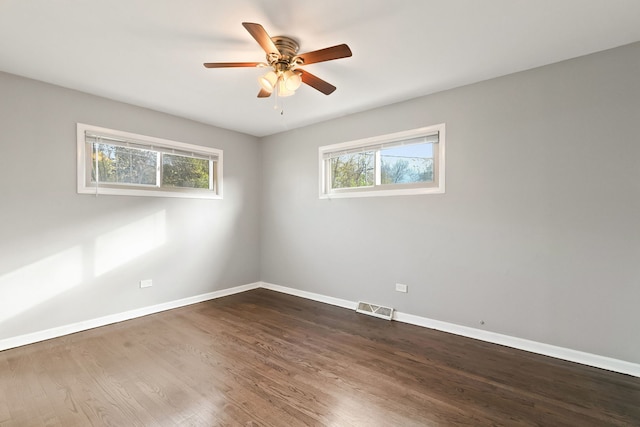 empty room featuring dark hardwood / wood-style floors and ceiling fan