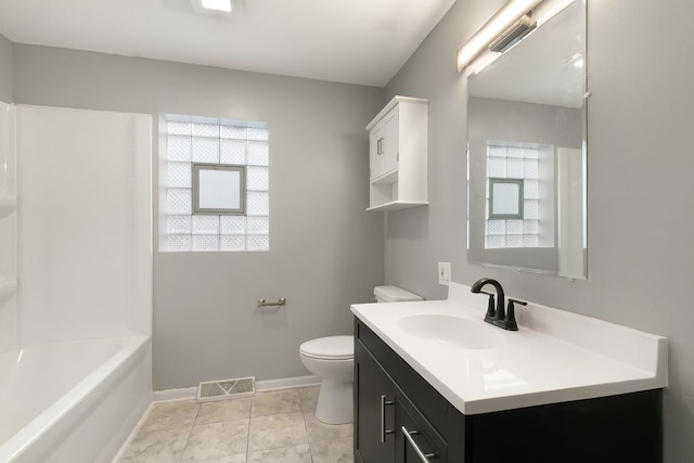 bathroom featuring a wealth of natural light, tile patterned flooring, vanity, and toilet