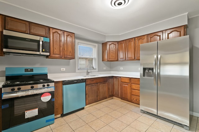 kitchen with sink, light tile patterned floors, and stainless steel appliances