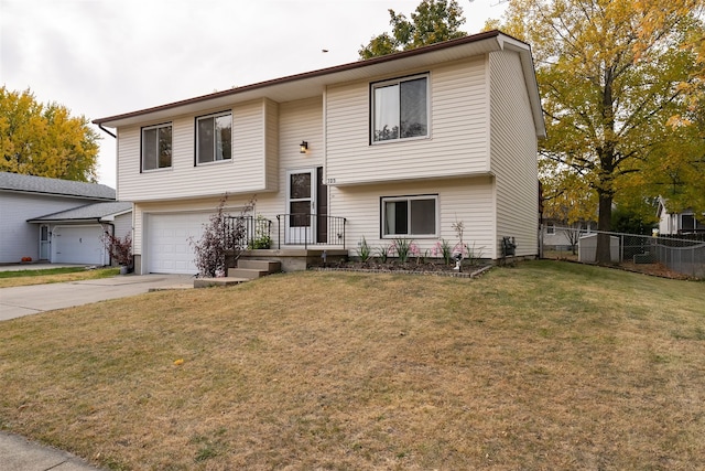 bi-level home with a front yard and a garage