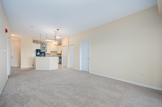 unfurnished living room featuring light colored carpet